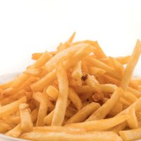 Golden French fries potatoes on white